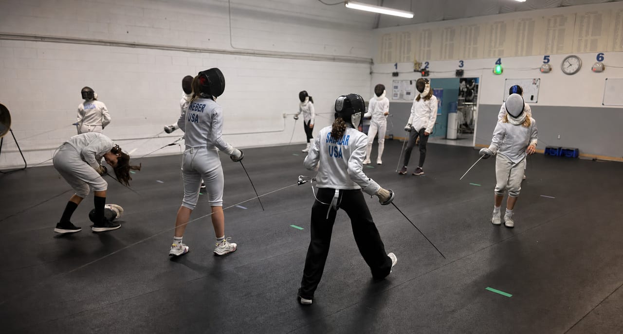 NCF Boulder youth fencers training on the strips during a club practice