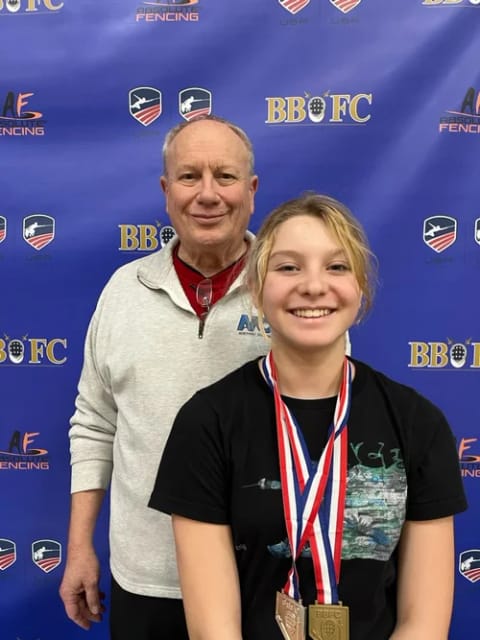 Maddie Burks with her head coach Gary Copeland at NCF Boulder fencing club